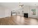 Open-concept living room with fireplace, adjacent kitchen and wood-look flooring at 2621 Wellington Ridge Loop, Cary, NC 27518
