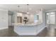 Open-concept kitchen featuring a granite-topped breakfast bar and stainless steel appliances at 275 Cardovia Way, Wendell, NC 27591