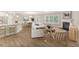 Bright, open-concept living room with hardwood floors, a fireplace, and lots of natural light at 275 Cardovia Way, Wendell, NC 27591