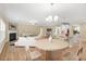 Open-concept living area featuring a fireplace, hardwood floors, and a breakfast bar at 275 Cardovia Way, Wendell, NC 27591