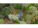 Aerial view of a beautiful house surrounded by lush greenery and blooming trees, showcasing its serene setting at 2820 Mattlyn Ct, Raleigh, NC 27613