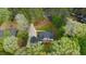 Aerial view of a secluded home with mature trees, a long private driveway, and a backyard deck at 2820 Mattlyn Ct, Raleigh, NC 27613