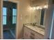 Bright bathroom featuring double sinks with granite countertop, framed mirror, and glass-enclosed shower at 2820 Mattlyn Ct, Raleigh, NC 27613