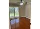 Bright bedroom with hardwood floors and a ceiling fan with a large window offering natural light at 2820 Mattlyn Ct, Raleigh, NC 27613