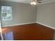 Large bedroom with hardwood floors, a ceiling fan and a window offering natural light at 2820 Mattlyn Ct, Raleigh, NC 27613
