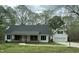 Charming home featuring a covered porch, attached garage, and mature trees, offering classic curb appeal at 2820 Mattlyn Ct, Raleigh, NC 27613