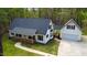 Charming single-Gathering home featuring a cozy front porch and attached two-car garage nestled among lush trees at 2820 Mattlyn Ct, Raleigh, NC 27613