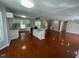 Open concept kitchen featuring white cabinets, granite countertops and an island with an open view to the dining area at 2820 Mattlyn Ct, Raleigh, NC 27613
