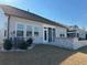 A backyard with stone patio and retaining wall adjacent to the house at 2918 Balbardie Dr, Apex, NC 27502