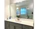 Well-lit bathroom with gray vanity, marble shower and large mirror reflecting adjacent bathroom elements at 2918 Balbardie Dr, Apex, NC 27502
