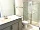 Bright bathroom with a marble tiled shower, glass door and a gray vanity at 2918 Balbardie Dr, Apex, NC 27502