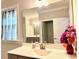 Modern bathroom featuring a large mirror, quartz countertops, and a window with natural light at 2918 Balbardie Dr, Apex, NC 27502