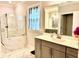 Modern bathroom featuring a glass-enclosed shower, quartz countertops, and gray vanity at 2918 Balbardie Dr, Apex, NC 27502