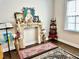 Cozy, well-lit bedroom featuring an ornate fireplace and large window at 2918 Balbardie Dr, Apex, NC 27502