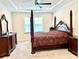 Spacious bedroom features a four-poster bed, ceiling fan, and plenty of natural light at 2918 Balbardie Dr, Apex, NC 27502