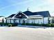 A view of the well-maintained clubhouse featuring architectural wood details and nice landscaping at 2918 Balbardie Dr, Apex, NC 27502
