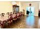 Bright dining room features a large table, hardwood floors, elegant chandelier and sliding glass doors to patio at 2918 Balbardie Dr, Apex, NC 27502