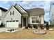 Charming home featuring stone accents, neutral siding, a well-manicured lawn, and an attached two-car garage at 2918 Balbardie Dr, Apex, NC 27502