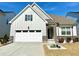 Charming home featuring stone accents, neutral siding, a well-manicured lawn and an attached two-car garage at 2918 Balbardie Dr, Apex, NC 27502