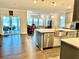 Bright, open kitchen featuring stainless steel appliances, granite countertops, and hardwood floors at 2918 Balbardie Dr, Apex, NC 27502