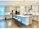 A spacious kitchen with stainless steel appliances, a center island with seating, and modern lighting fixtures at 2918 Balbardie Dr, Apex, NC 27502