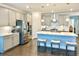 A spacious kitchen with stainless steel appliances, a center island with seating, and modern lighting fixtures at 2918 Balbardie Dr, Apex, NC 27502