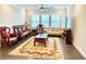 A well-lit formal living room featuring hardwood floors, large windows and unique furniture at 2918 Balbardie Dr, Apex, NC 27502