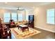 A well-lit formal living room featuring hardwood floors, large windows and unique furniture at 2918 Balbardie Dr, Apex, NC 27502