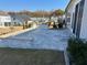A stone patio is showcased in a backyard, featuring a stylish and functional design at 2918 Balbardie Dr, Apex, NC 27502