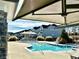 A relaxing community pool with canopies, lounge chairs and a view of community homes at 2918 Balbardie Dr, Apex, NC 27502