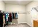 Walk-in closet providing ample storage with organized hanging space and neutral carpeting at 2918 Balbardie Dr, Apex, NC 27502