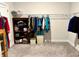 Walk-in closet providing ample storage with organized hanging space and neutral carpeting at 2918 Balbardie Dr, Apex, NC 27502
