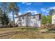 Exterior shot of the home's backyard showing the deck, lawn, and fencing at 3 Guilder Cv, Durham, NC 27713