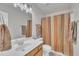 Neutral bathroom featuring a shower with curtain, vanity, and mirror at 3 Guilder Cv, Durham, NC 27713