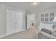 Bright bedroom featuring a double door closet, modern changing table, and neutral color palette at 3 Guilder Cv, Durham, NC 27713