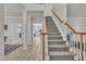 Spacious foyer featuring a carpeted staircase and wood-look floors at 3 Guilder Cv, Durham, NC 27713