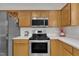 Kitchen featuring stainless steel appliances, light countertops, and wood cabinetry at 3 Guilder Cv, Durham, NC 27713