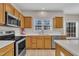 Kitchen featuring stainless steel appliances, light countertops, and wood cabinetry at 3 Guilder Cv, Durham, NC 27713