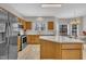 Well-lit kitchen featuring stainless steel appliances and a center island with a white countertop at 3 Guilder Cv, Durham, NC 27713