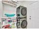 Well-organized laundry room with modern washer/dryer unit, shelving, and ample storage space for convenience at 3 Guilder Cv, Durham, NC 27713
