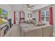 Cozy living room with large sectional sofa, ceiling fan, television, and window with red curtains at 3 Guilder Cv, Durham, NC 27713