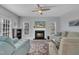 Cozy living room features a fireplace, plush seating, and large windows that enhance the space with natural light at 3 Guilder Cv, Durham, NC 27713