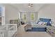Bright main bedroom with tray ceilings, ceiling fan, crib, dresser, and plentiful windows at 3 Guilder Cv, Durham, NC 27713