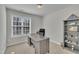 Bright home office with a large window, a sleek desk, and ample shelving for organization and productivity at 3 Guilder Cv, Durham, NC 27713