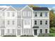 New construction townhome featuring a blue front door, gray siding, and white-trimmed windows at 315 Deercroft Dr, Apex, NC 27539