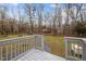 Spacious backyard with grass and partial wooden deck at 315 Dumont Dr, Hillsborough, NC 27278