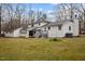 Large backyard featuring a two-story white home, deck and green grass at 315 Dumont Dr, Hillsborough, NC 27278