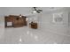 Finished basement with brick fireplace, piano, tile flooring, and ceiling fans at 315 Dumont Dr, Hillsborough, NC 27278