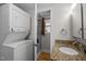 Cozy bathroom with stacked washer and dryer, shower stall and granite countertop at 315 Dumont Dr, Hillsborough, NC 27278
