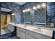 Bathroom featuring double sinks, blue floral wallpaper, and white tile flooring at 315 Dumont Dr, Hillsborough, NC 27278